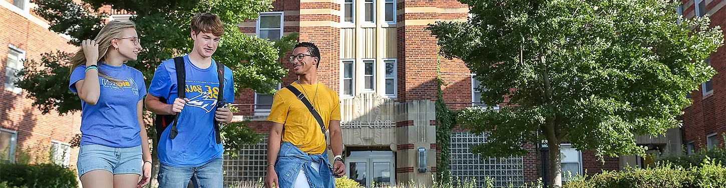 students walking across campus on a sunny afternoon